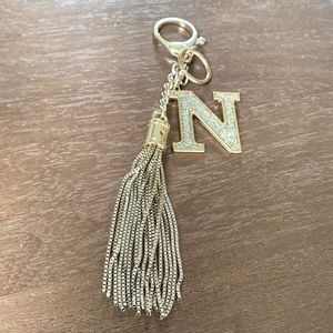 Purse charm with golden metal tassel and bling letter N